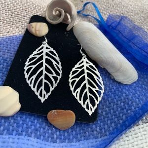 Silver tone pierced leaf earrings